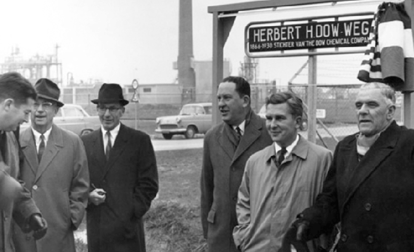 Men standing outside Dow sign
